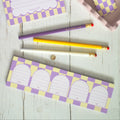 Checkered notebooks and stationery items on a wooden surface